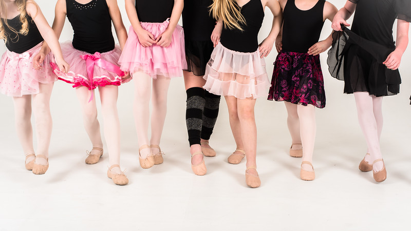 A lineup of young dancers in tutus and ballet slippers