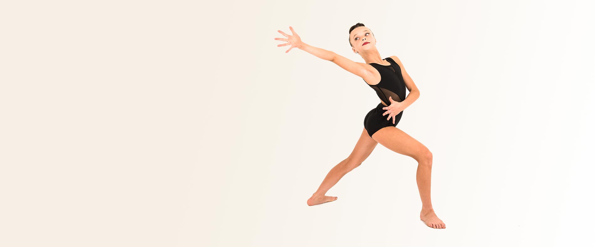 A Tueller dancer mid-movement, arm outstretched